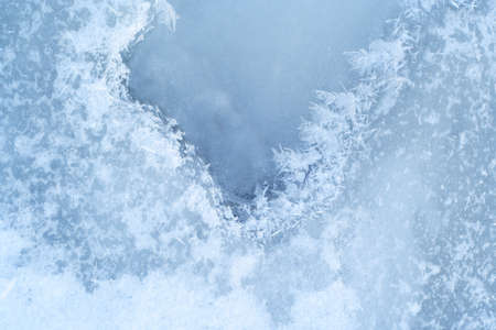 close-up ice-bound water surface with crystals pattern at the winter timeの写真素材