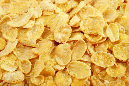Yellow cornflakes texture close up photo