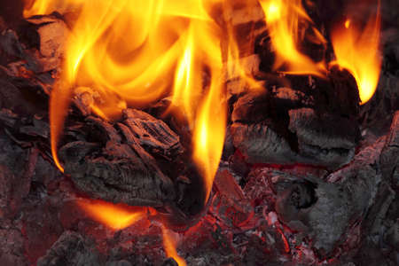Bonfire close up with flames, red heat and ash