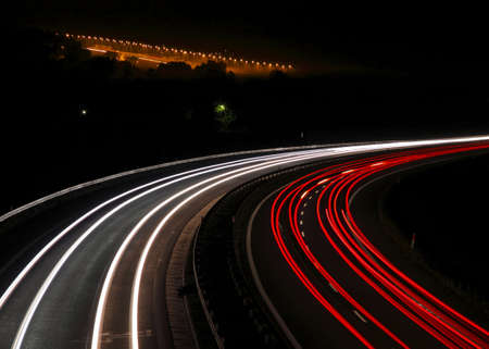 Highway with car lights trails at night