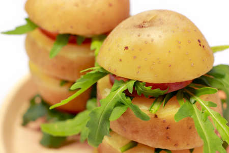 Close-up of boiled and sliced potato towers with rocketの写真素材