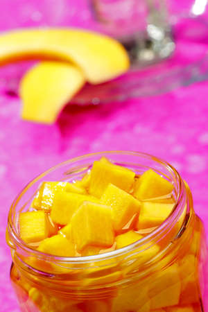 Pickled pumpkin cubes in opened jar with unfocused backgroundの写真素材