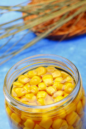 Preserved sweetcorn in opened jar with unfocused backgroundの写真素材