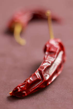 Close-up of dried chilli peppers on textile backgroundの写真素材