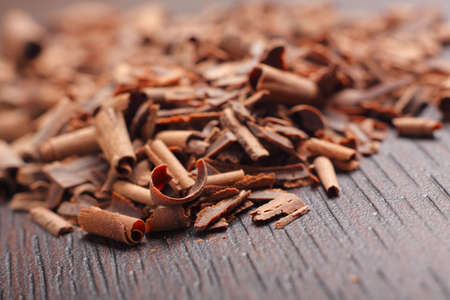 Chocolate curls on dark table. Close-up photo.の写真素材