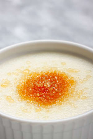 Detail of ramekin filled by wheat semolina (farina) with milk and brown cane sugar. Focus on sugar.の写真素材