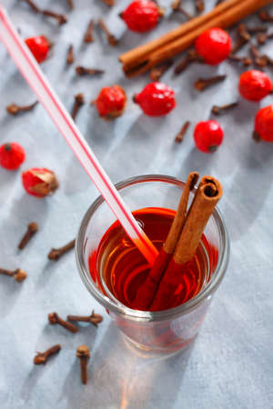 Red drink with a cinnamon stick and a drinking strawの写真素材