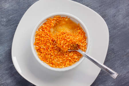 Stuffed apple dessert with grated coconut kernel topping. Overhead view.の写真素材