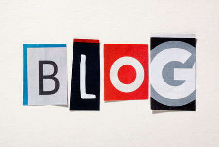 The word Blog from cut out magazine letters glued to a white paperの写真素材