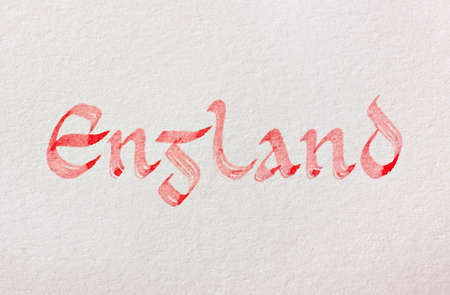 Handwritten country name over white paper background. England. Latin medieval insular script. English language.の写真素材