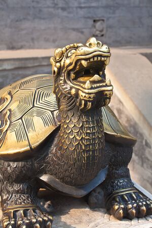 Close-up bronze turtle on the stone for travel designの写真素材