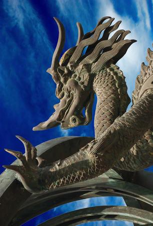 Bronze dragon on the blue sky backgroundの写真素材