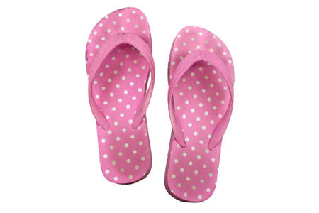 old slippers in pink polka dot pattern isolated on white backgroundの写真素材