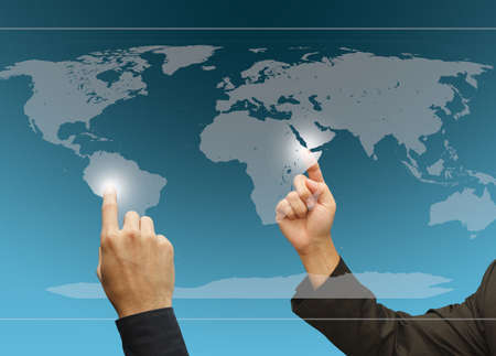 Two business hands point to difference target on the world touch screen