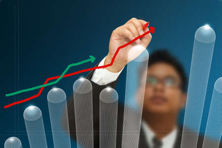 Business man hand drawing arrow up graphs on touch screen.