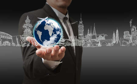businessman hand holding the dream travel around the worldの写真素材