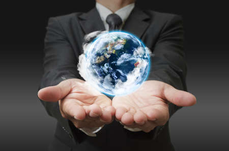 hands holding the earth globe in his handの写真素材