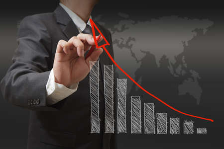 Male hand drawing a chart on whiteboardの写真素材