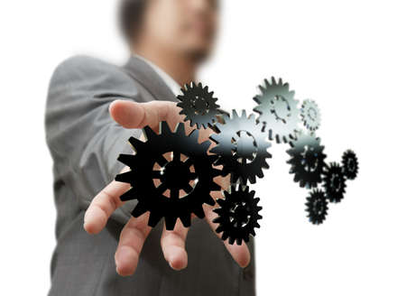 Businessman shows gear to success on white backgroundの写真素材