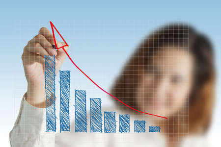 female hand drawing a chart of success businessの写真素材