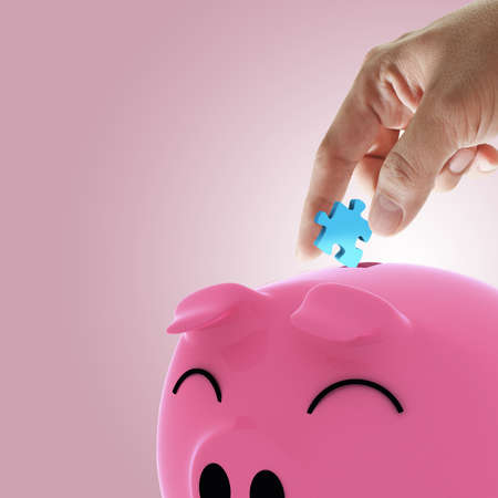 hand picking puzzle to piggy bank as concept