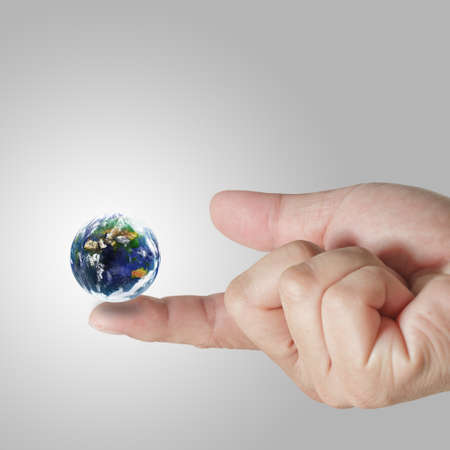 earth globe on his finger Elements of this image furnished by NASA の写真素材