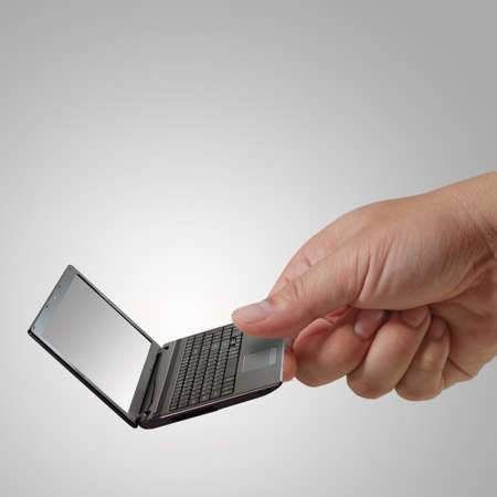 hand picks laptop as concept technologyの写真素材