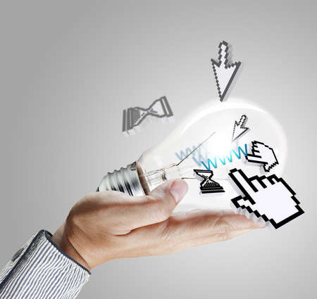 hand holds light bulb and computer cursor as conceptの写真素材