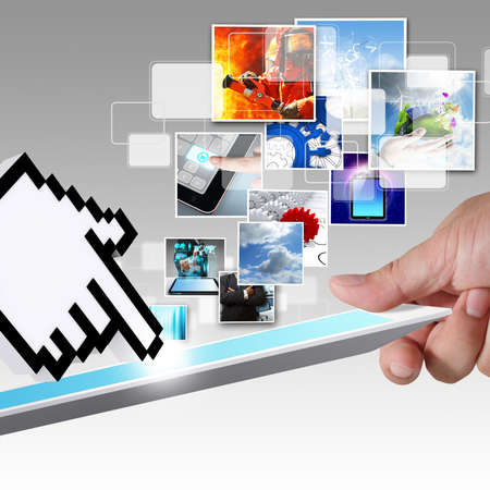 close up of hand holds tablet computer and hand cursor streaming imagesの写真素材