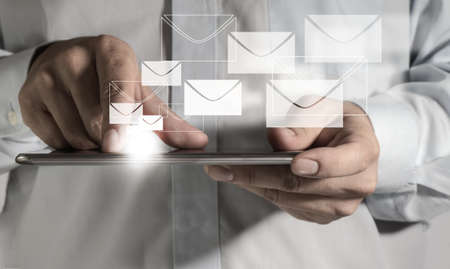 close up of business man hand hold touch screen mobile phone and buttons e-mailの写真素材
