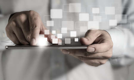 Young adult working on a digital tabletの写真素材