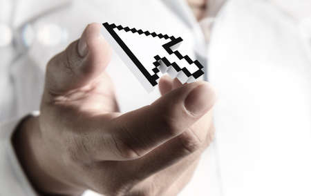 close up of hand fingers picking up arrow cursor as computer concept