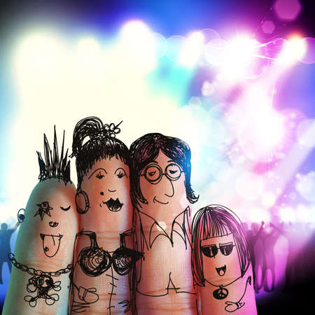 happy family with painted smiley on human fingers at music concertの写真素材