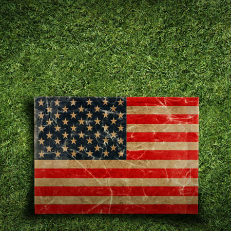 Grunge paper flag of USA on grassの写真素材