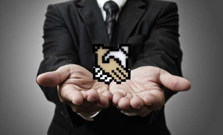 business man hand shows pixel handshake icon signの写真素材