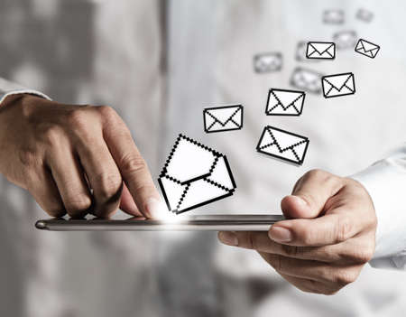 Business hand hold Touch screen computer and pixel e-mail iconの写真素材