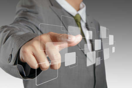 business man hand pushing on a virtual touch screen interfaceの写真素材