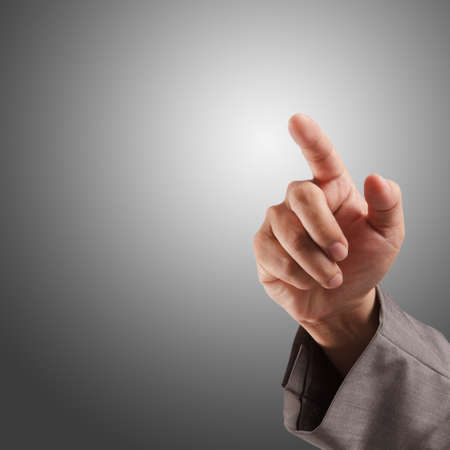 business hand touching screen on grey backgroundの写真素材