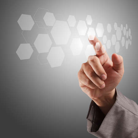 business man hand pushing on a virtual touch screen interfaceの写真素材