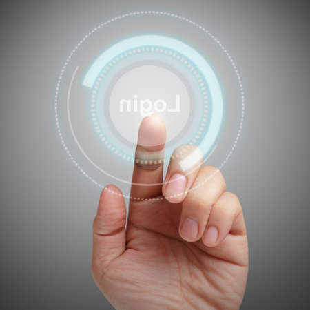 hand pushing LOGIN button on dark backgroundの写真素材