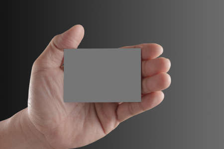Businessman's hand holding blank paper business cardの写真素材