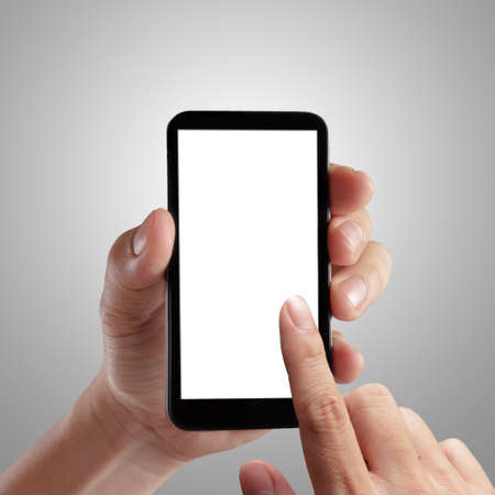 Hand holding mobile smart phone with blank screen. Isolated on white.の写真素材