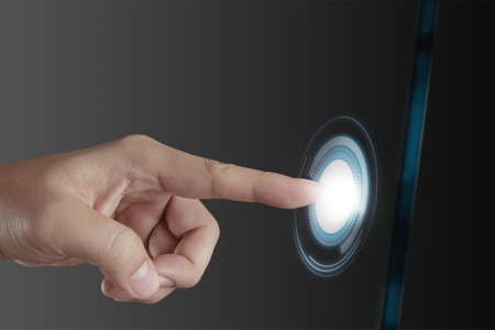 businessman hand pushing on a touch screen interfaceの写真素材