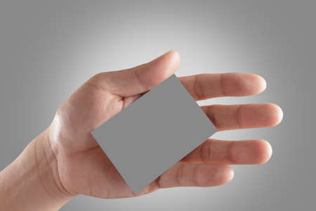 Businessman's hand holding blank paper business cardの写真素材