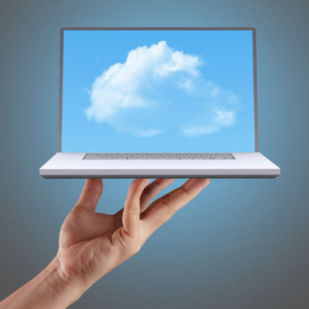 hand shows cloud computing, laptop in front of virtual cloud.の写真素材