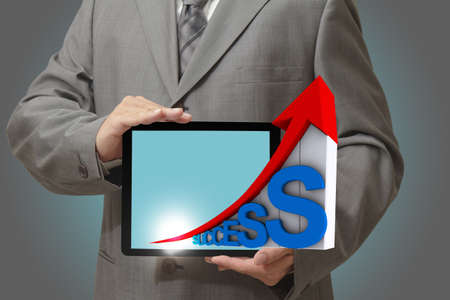 Modern people doing business, graphs and charts being demonstrated on the screen of a touch-padの写真素材