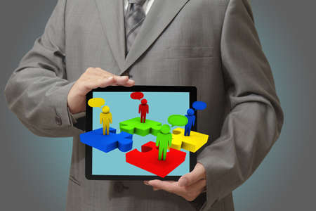 Modern people doing business, graphs and charts being demonstrated on the screen of a touch-padの写真素材