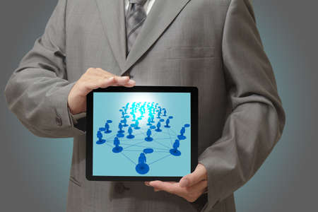 Modern people doing business, graphs and charts being demonstrated on the screen of a touch-padの写真素材