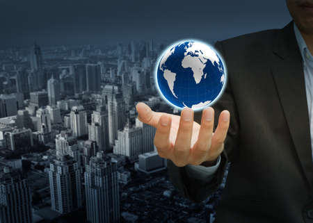 holding a glowing earth globe in his handsの写真素材