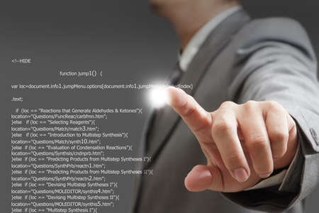 Young stylish businessman touching virtual interface button. Pillar of transparent blue light....